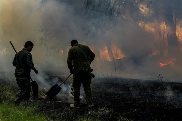 Members of an emergency squad try to extinguish a forest fire caused from rockets fired from Lebanon, near the northern Israeli town of Kiryat Shmona, June 4, 2024 (Photo: Ayal Margolin/Flash90).