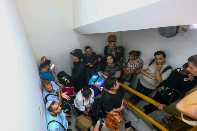 Israelis take cover inside a bomb shelter at the Ben Gurion airport as a siren alert is sounded in Tel Aviv, October 1, 2024. Photo by Dor Pazuelo/Flash90