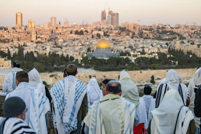 Jewish men cover with prayer shwals during Sukkot at a lookout of the Mount of Olives, overlooking the Old city of Jerusalem on October 23, 2024. Photo by Yonatan Sindel/Flash90