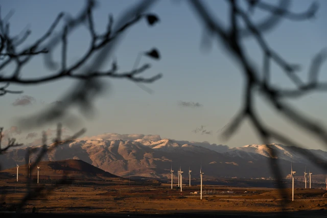 A station of wind turbines with snowy Mount Hermon in the background in the Golan Heights, November 26, 2024. Photo by Michael Giladi/ Flash90