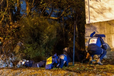 People take cover as siren warns of incoming missile fired from Yemen, near Rehovot, December 30, 2024. Photo by Yossi Aloni/Flash90