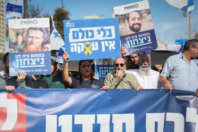 Israelis march as part of a protest against the ceasefire between Israel and Hamas, outside PM Netanyahu's office in Jerusalem. Signs read: "Without everyone, there is no deal; With their death they ordered us to live" ,in their death they order us life,  January 16, 2025. Photo by Yonatan Sindel/FLASH90
