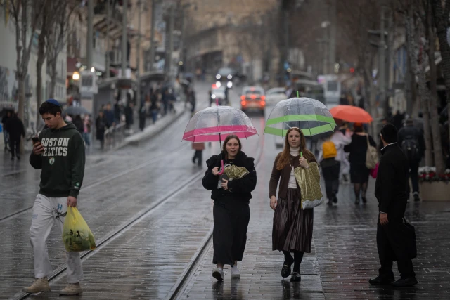 People walking in the rain on Jaffa street in Jerusalem, on January 23, 2025. Photo by Chaim Goldberg/Flash90