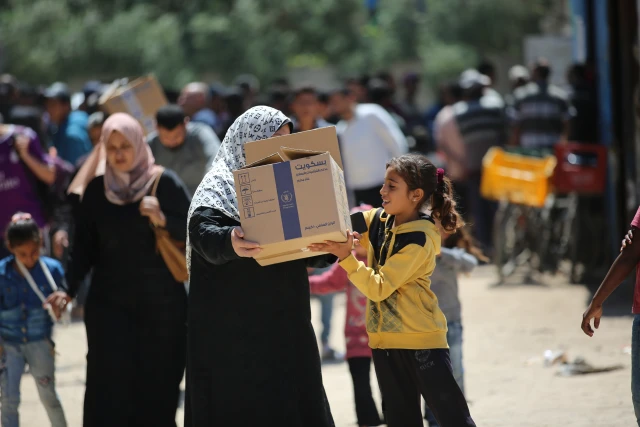 Palestinians receive food aid from the World Food Programme (WFP) at the Nuseirat Refugee Camp, in the central Gaza Strip, April 26, 2025. Photo by Ali Hassan/Flash90