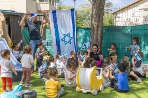 Israeli children play with Israeli flags ahead of Israel's 77th Independence Day, at "Kobi kindergarden" in Moshav Yashresh, on April 29, 2025. Photo by Yossi Aloni/Flash90
