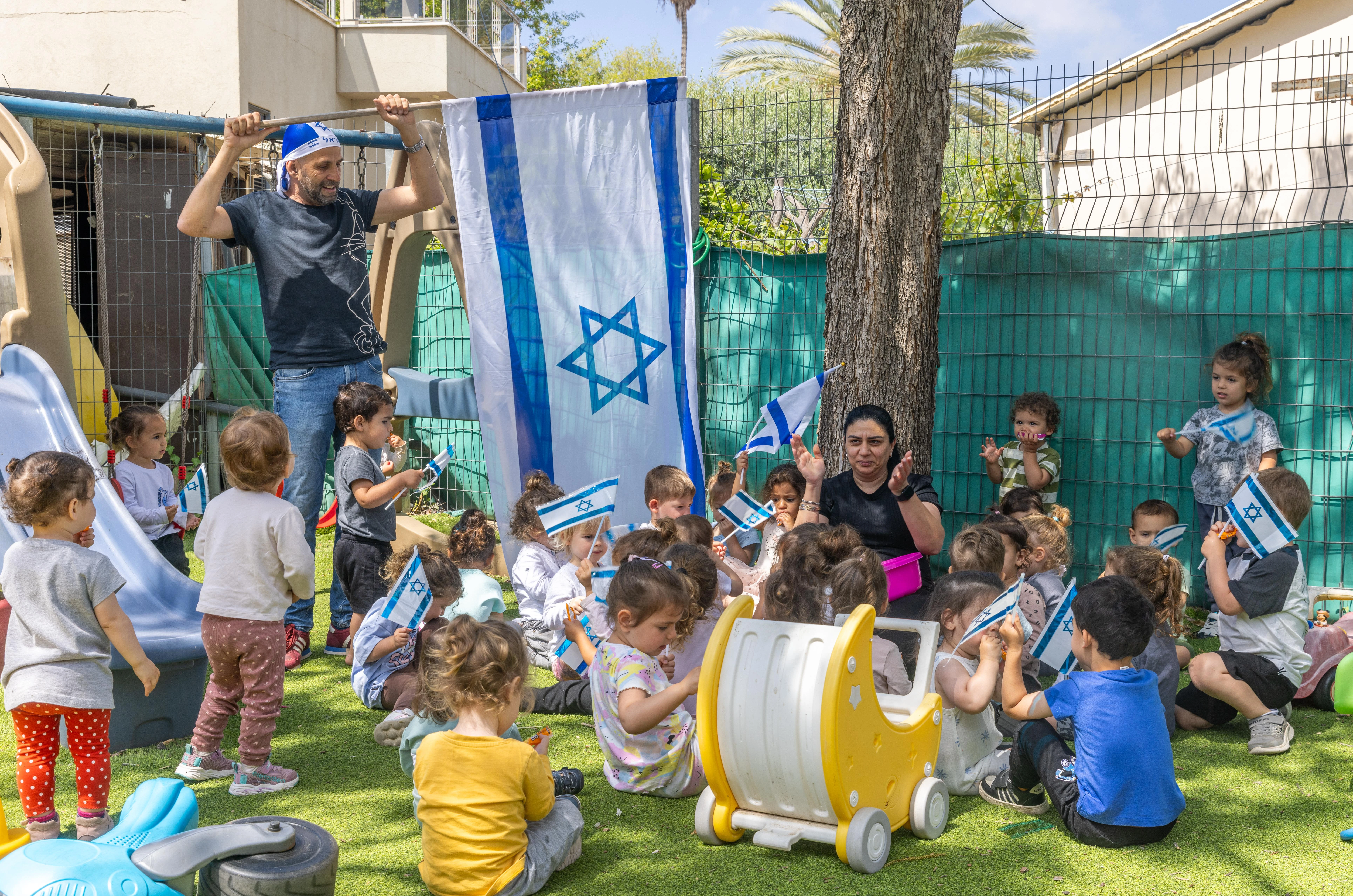 Israeli children play with Israeli flags ahead of Israel's 77th Independence Day, at "Kobi kindergarden" in Moshav Yashresh, on April 29, 2025. Photo by Yossi Aloni/Flash90