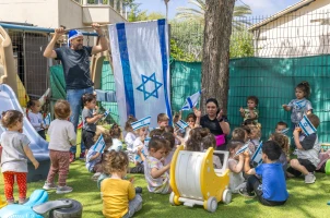 Israeli children play with Israeli flags ahead of Israel's 77th Independence Day, at "Kobi kindergarden" in Moshav Yashresh, on April 29, 2025. Photo by Yossi Aloni/Flash90
