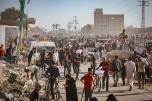 Palestinians carrying bags of flour outside distribution point controlled by the 'Gaza Humanitarian Relief Foundation' in Deir al-Balah, in the Gaza Strip, May 28, 2025. Photo by Ali Hassan/Flash90