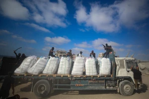 Armed Palestinians sit on trucks carrying humanitarian aid near the Zikim border crossing between Israel and Beit Lahia in the northern Gaza Strip, June 25, 2025. Photo by Ali Qariqa/Flash90