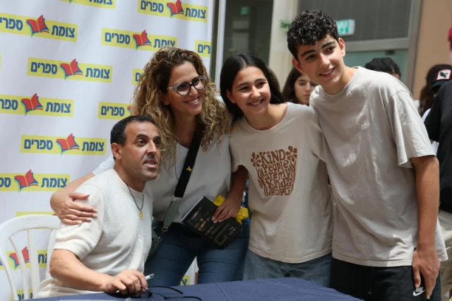 Released hostage Eli Sharabi signs his book “Hostage", during an event in Modi'in, July 2, 2025. Photo by Jonathan Shaul/Flash90