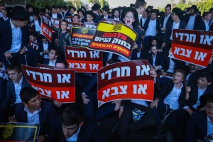 Ultra-Orthodox Jewish men block a road outside Bnei Brak, during a protest against the arrest of three yeshiva students for refusing to enlist in the Israeli military, July 23, 2025. Photo by David Cohen/Flash90