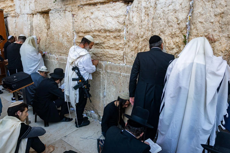Jewish men pray during the Tisha B’Av ritual at the Western Wall in Jerusalem’s Old City, August 3, 2025. Photo by Chaim Goldberg/Flash90