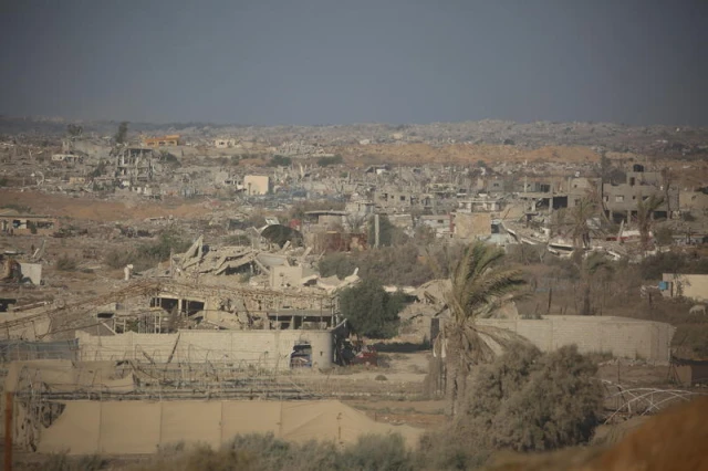 People walk near destroyed buildings following an Israeli airstrike in Gaza City, September 16, 2025, after Israel launched a large-scale operation in the city. Photo by Ali Hassan/Flash90