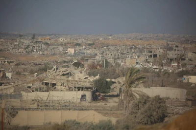 People walk near destroyed buildings following an Israeli airstrike in Gaza City, September 16, 2025, after Israel launched a large-scale operation in the city. Photo by Ali Hassan/Flash90