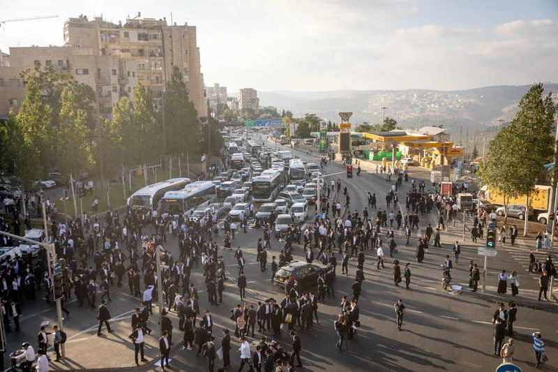 Ultra Orthodox Jewish men block a road during a protest against the jailing of Jewish seminary students who failed to comply with an army recruitment order in Jerusalem on September 18, 2025. Photo by Chaim Goldberg/Flash90