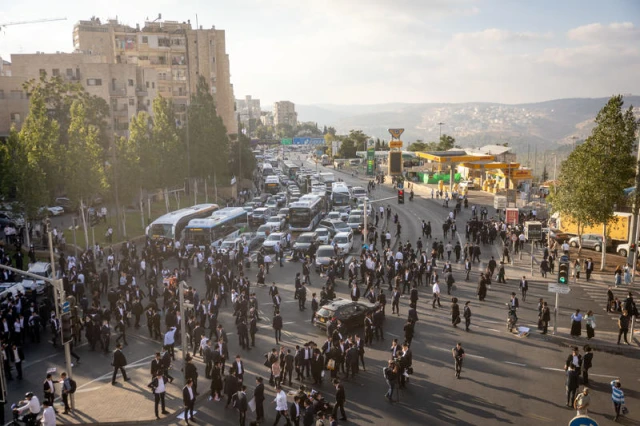Ultra Orthodox Jewish men block a road during a protest against the jailing of Jewish seminary students who failed to comply with an army recruitment order in Jerusalem on September 18, 2025. Photo by Chaim Goldberg/Flash90
