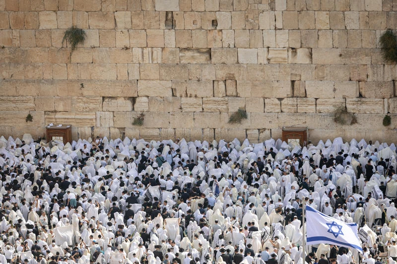 Jewish worshippers pray at the Western Wall, Judaism's holiest prayer site, in Jerusalem's Old City, during the Cohen Benediction priestly blessing at the Jewish holiday of Sukkot, October 09, 2025. Photo by Chaim Goldberg/Flash90