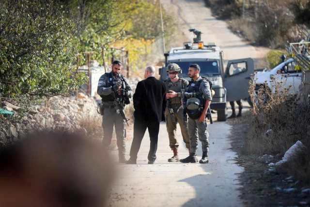 Palestinians stand guard against a settler attack in the town of Halhul, north of Hebron on November 20, 2025. Photo by Wisam Hashlamoun/FLASH90