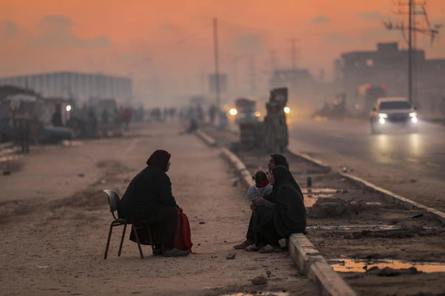 Displaced Palestinians are seen on a street in Nuseirat camp, in the central Gaza Strip, on December 17, 2025. Photo by Ali Hassan/Flash90