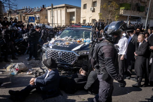 Ultra Orthodox Jewish men clash with police during a protest against the jailing of a Jewish seminary student who failed to comply with an army recruitment order, on Bar Ilan road, Jerusalem. December 18, 2025. Photo by Chaim Goldberg/Flash90