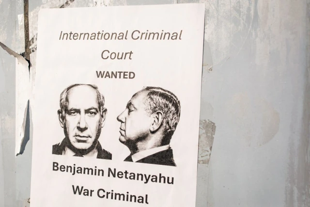 Washington, D.C. US - December 27, 2024: a poster accusing Benjamin Netanyahu to be a war criminal wanted by International Criminal Court with his mugshot in the center. Photo: Shutterstock.