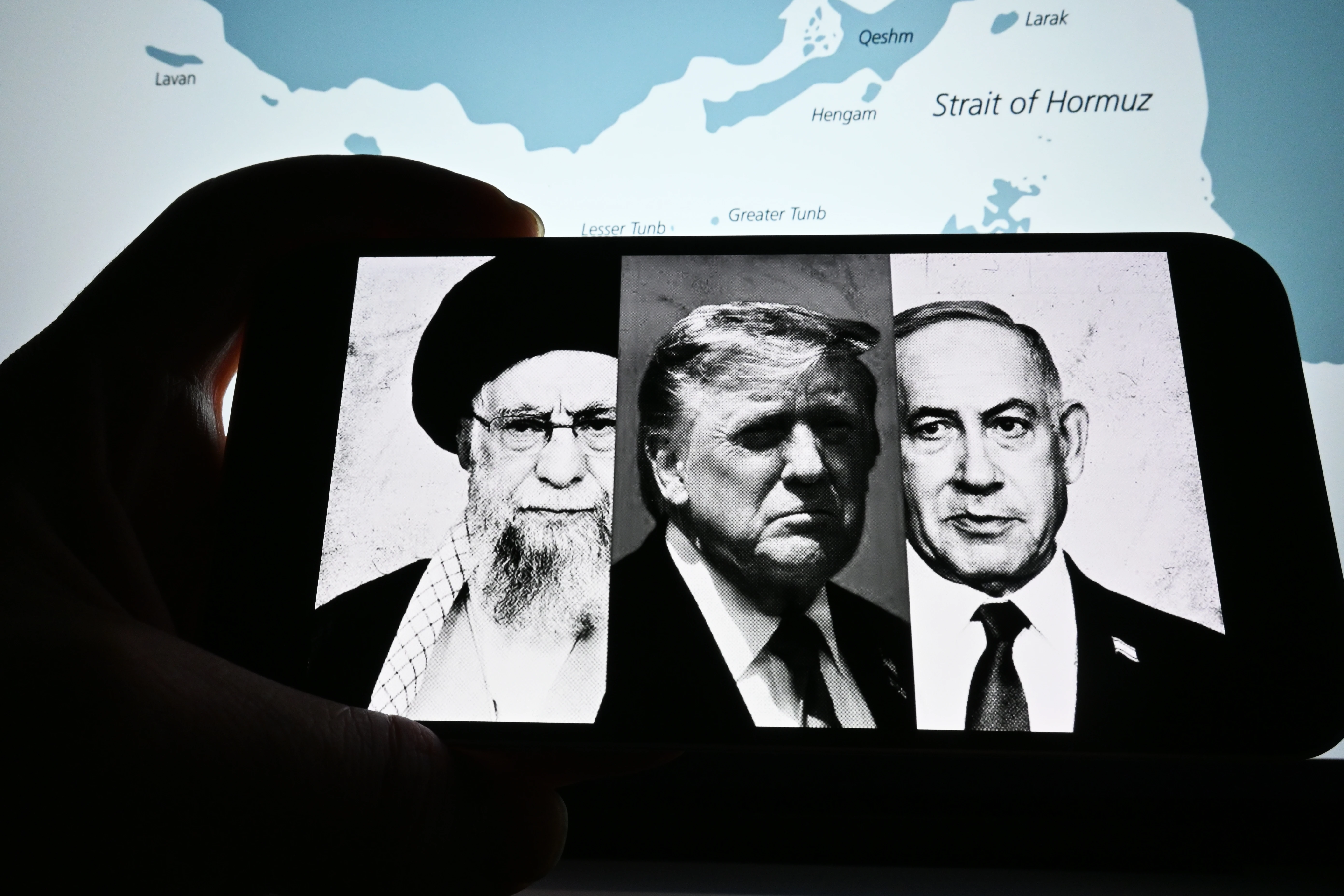 Photos of Trump, Netanyahu, and Khamenei are visible on the screen. Photo: Miss.cabul/Shutterstock.