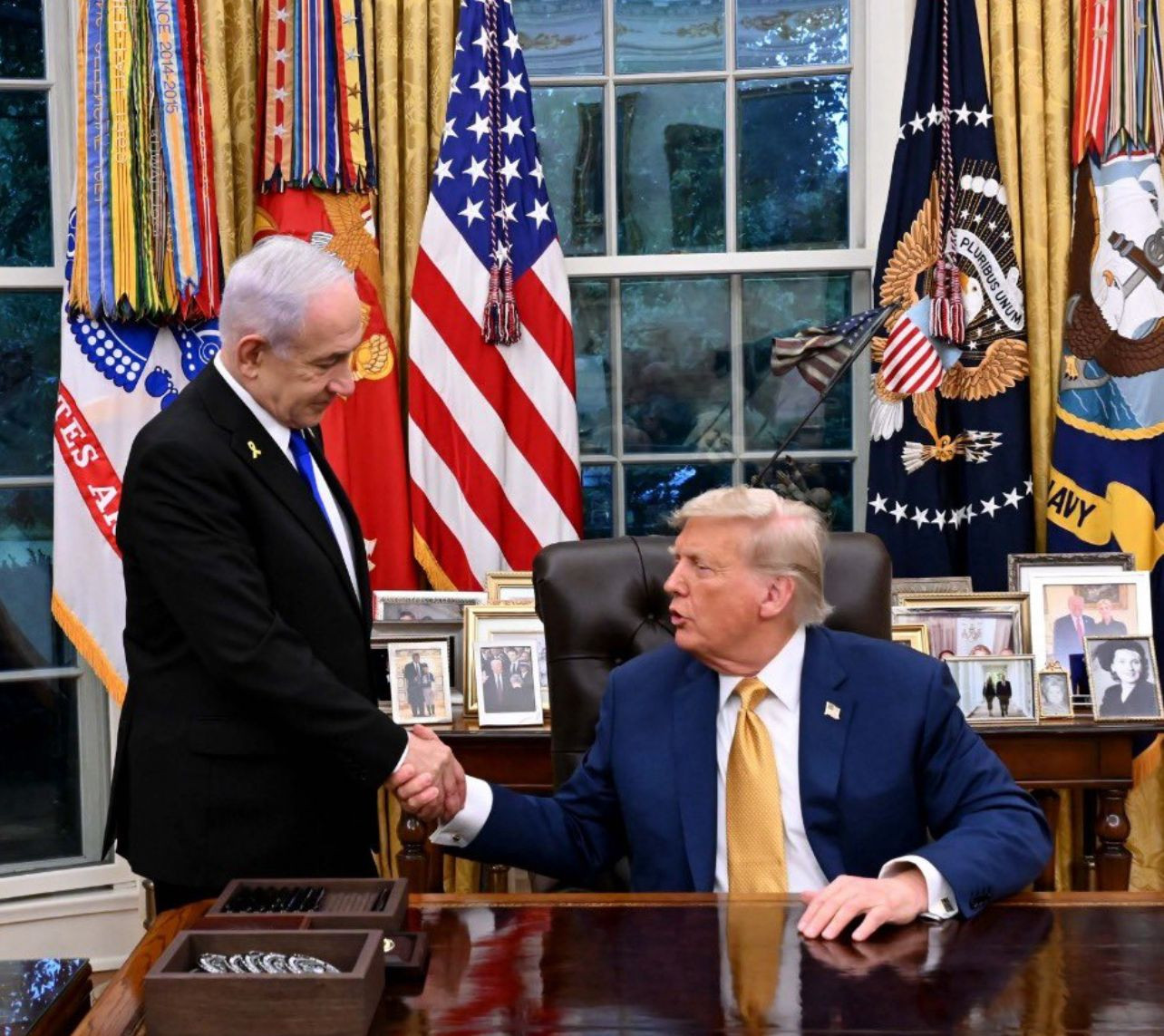 Israeli Prime Minister Benjamin Netanyahu and US President Donald Trump shake hands in the Oval Office. Credit: GPO