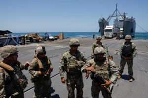 Soldiers stand at Trident Pier, a temporary pier to deliver aid, off the Gaza Strip, amid the ongoing conflict between Israel and Hamas, near the Gaza coast, June 25, 2024. 
REUTERS/Amir Cohen