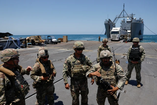 Soldiers stand at Trident Pier, a temporary pier to deliver aid, off the Gaza Strip, amid the ongoing conflict between Israel and Hamas, near the Gaza coast, June 25, 2024. 
REUTERS/Amir Cohen