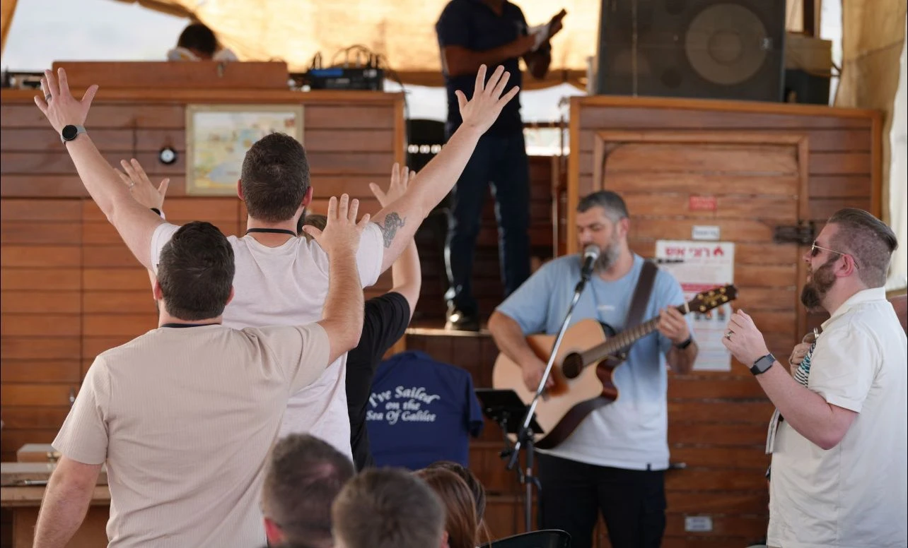 Worshiping and praying on the Sea of Galilee. Photo credit: Joshua Fund and Faith Wins staff