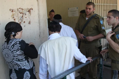 Ultra-orthodox Jewish men arrive at the Bakum Reception and Sorting base in Tel Hashomer in Israel, on August 1, 2013. The largest numbers so far of ultra-orthodox new recruits to the Israeli army arrived at the Bakum army base on August 1. Most of them are expected to be absorbed in the Netzah Yehuda Battalion, under the Nahal Haredi. Photo by Flash90