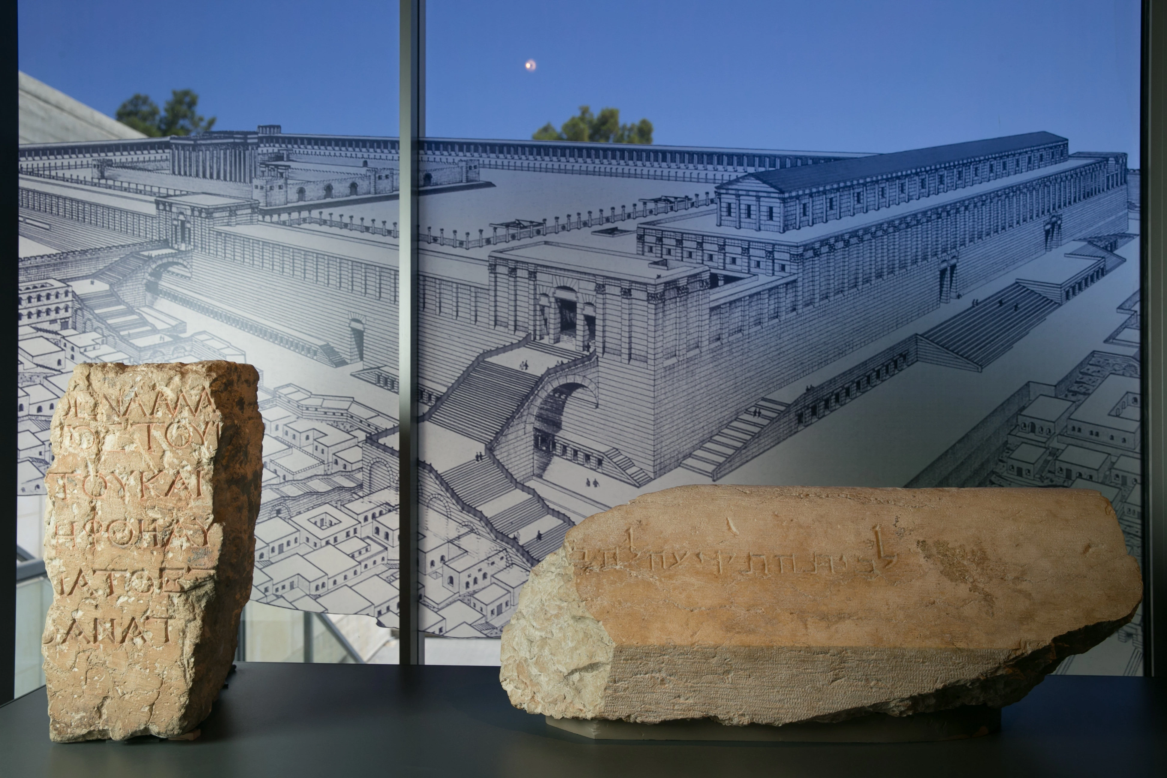 Artifacts from the Second Temple period displayed at the Israel Museum in Jerusalem:
(left) a limestone inscription in Greek warning non-Jews not to enter the Temple, and (right) a stone fragment inscribed in Hebrew, “to the place of trumpeting,” from the Temple Mount. July 20, 2015. (Photo: Nati Shohat/Flash90)