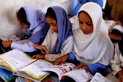 Students listen to their teacher during a lesson at the outstrike of Lahore, Pakistan, May 14, 2016. (Photo: Sutterstock)