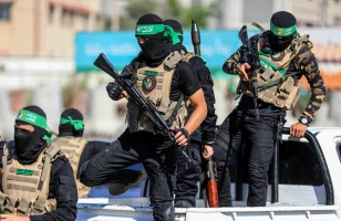 Masked members of the al-Qassam Brigades, the military wing of Hamas, during a march on the 8th anniversary of the kidnapping of the Israeli soldier Shaul Aron in 2014, Gaza City, on July 20, 2022. Photo: Shutterstock