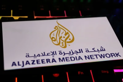 Illustrative image: Smartphone screen displaying the Al Jazeera Media Network logo, placed on a computer keyboard. Photo: Shutterstock.