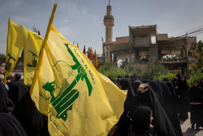 People holding Hezbollah flags during a funeral in Hanine, southern Lebanon, April 25, 2024. Photo: Shutterstock.