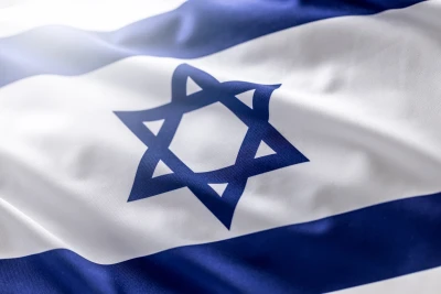 Israeli flag blowing in the wind - Close up. Photo: Shutterstock