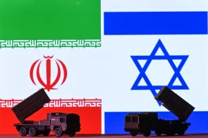 EDMONTON, CANADA - APRIL 15: Illustration depicting mini replicas of missile launcher systems placed in front of the Iranian and Israeli flags, displayed on a computer screen, on April 15, 2024, in Edmonton, Alberta, Canada. (Photo by Artur Widak/NurPhoto)