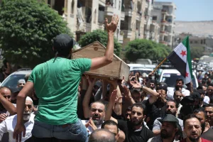 Syrians mourn dead people whose families said they were shot by the Turkish side in the city of Afrin in Aleppo Governorate. (Photo: Arab World Press via Reuters, July 2, 2024)