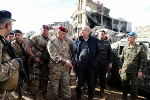 Lebanon's caretaker Prime Minister Najib Mikati, Lebanon's Army chief General Joseph Aoun and the Head of Mission and Force Commander of the United Nations Interim Force in Lebanon (UNIFIL) Aroldo Lazaro Saenz stand near rubble of damaged buildings from Israeli strikes, after the ceasefire between Israel and Hezbollah, during a visit to the Lebanese village of Khiam, December 23, 2024. REUTERS/Karamallah Daher