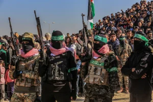 Hamas members and Palestinians watch as Israeli hostages are handed over to Red Cross representatives in the southern Gaza Strip city of Khan Younis.