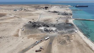 A drone view shows charred vehicles standing in the aftermath of what Al Masirah TV said was a U.S. strike on the Ras Isa fuel port, Al Jazirah, Yemen, in this screengrab from a handout video released on April 18, 2025. Al-Masirah TV/Handout via REUTERS
