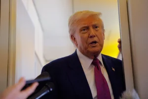 U.S. President Donald Trump talks to reporters aboard Air Force One, en-route to Abu Dhabi, United Arab Emirates, May 15, 2025. REUTERS/Brian Snyder