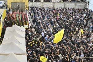 Hezbollah members carry a coffin while chanting political slogans during the funeral procession in Beirut, Lebanon, on November 24, 2025. (Photo via Reuters).