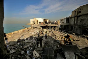 People inspect damage caused by an overnight Israeli air raid in the industrial area of Ghazieh on the outskirts of the southern Lebanese port city of Sidon. Israeli military launched strikes on southern and eastern parts Lebanon after warning it would hit what it called pro-Iranian Hezbollah and Palestinian Hamas targets, January 6, 2026 Photo: Marwan Naamani/ZUMA Press Wire via Reuters Connect