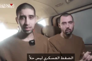 Evyatar David and Guy Gilboa-Dalal watch the broadcast of the release of fellow Israeli hostages in Nuseirat, central Gaza, on February 22, 2025. Photo: Screenshot from a video released by Hamas.