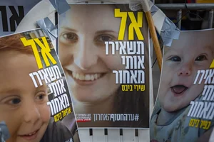 Pictures of Shiri Bibas and her children Kfir and Ariel hang outside the protest tent calling for the release of Israeli hostages in the Gaza Strip, outside the Prime Minister's residence in Jerusalem, February 19, 2025. Photo by Chaim Goldberg/Flash90