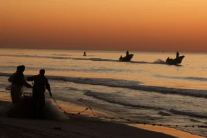 Palestinian fishermen are seen working at sunrise at the port of Gaza City. Fishing is a crucial livelihood for many Palestinians living in the impoverished territory. february 11, 2010. Photo by Wissam Nassar/FLASH90