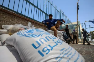 Palestinians receive food aid at a United Nations distribution center (UNRWA) in the southern Gaza Strip town of Rafah, on May 26, 2021. Photo by Abed Rahim Khatib/Flash90