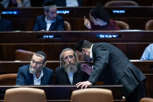 Illustration: MK Moshe Gafni of Degel HaTorah (United Torah Judaism) confers with fellow UTJ members during a Knesset plenum vote on reviving the ultra-Orthodox enlistment bill, Jerusalem, June 11, 2024. (Photo: Yonatan Sindel/Flash90)
